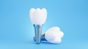 Two dental implants sitting on a blue background